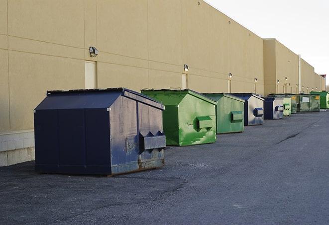 workers clearing construction waste into dumpsters in Ulm MT